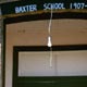 The front door of the old schoolhouse, bearing the dates of the school's operation.